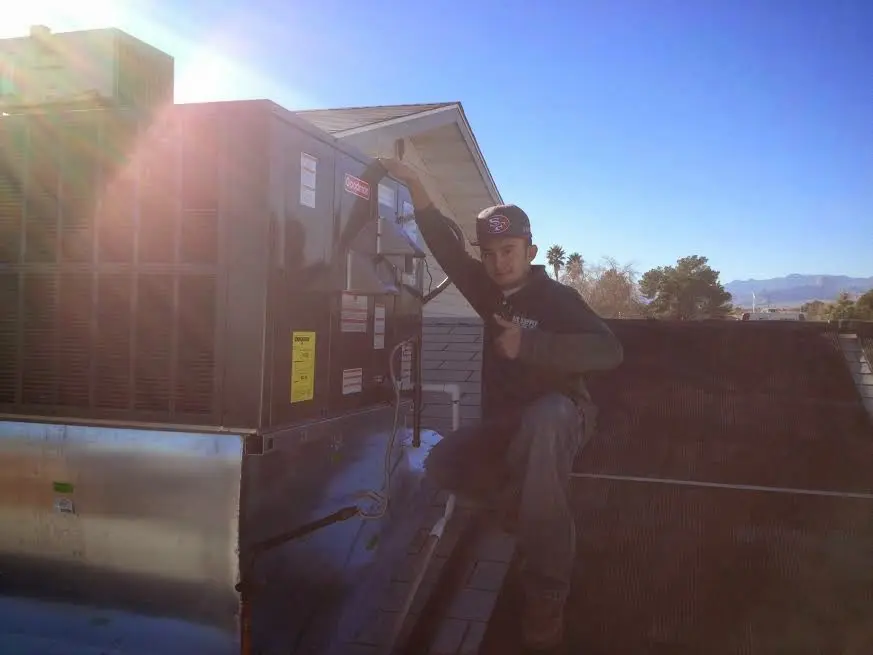 HVAC technician performing Heat Pump Repair on a rooftop unit in Vadnais Heights